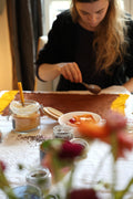 Women placing botanical elements onto natural fabric during a hands-on ecoprint workshop in Paris — Florilegium Paris